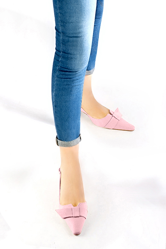 Women's light pink elegant slingback heels, with a bow on the front. Tapered toe. Medium spool heels - Worn view